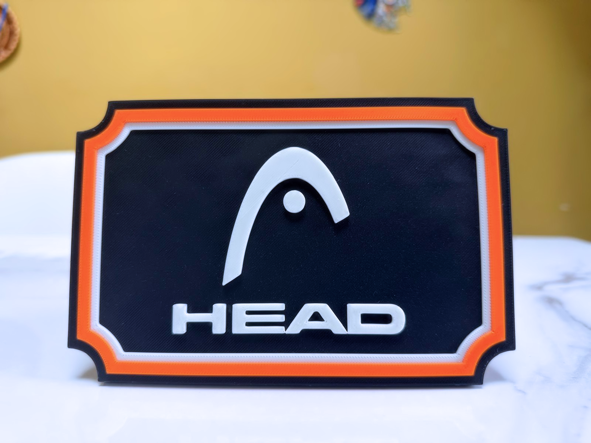 HEAD Inspired Tennis Wall Plaque, Black White & Orange, 17cm